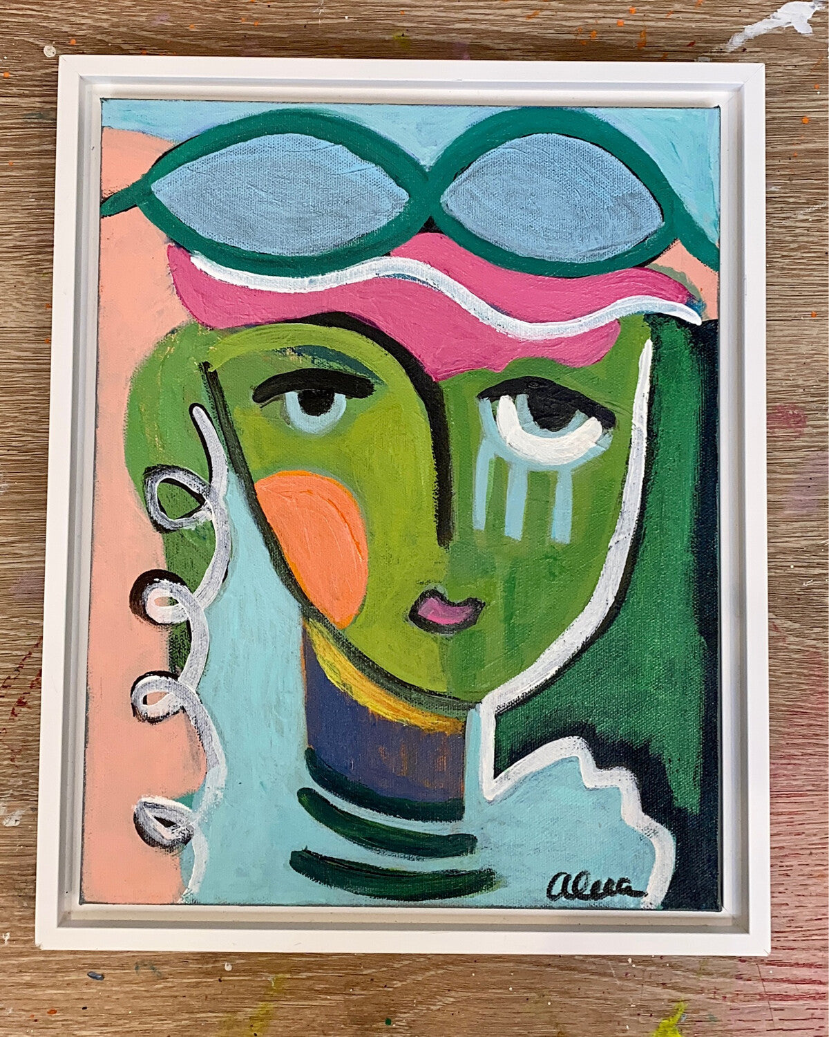 Abstract portrait of a woman with a green face; blue, orange, and pink are prominent colors.