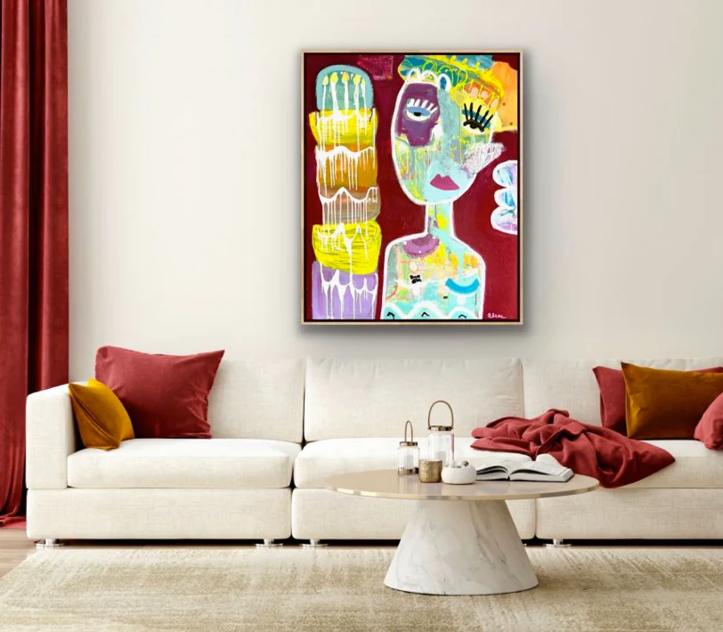 A maroon abstract painting hangs in a white and maroon living room.