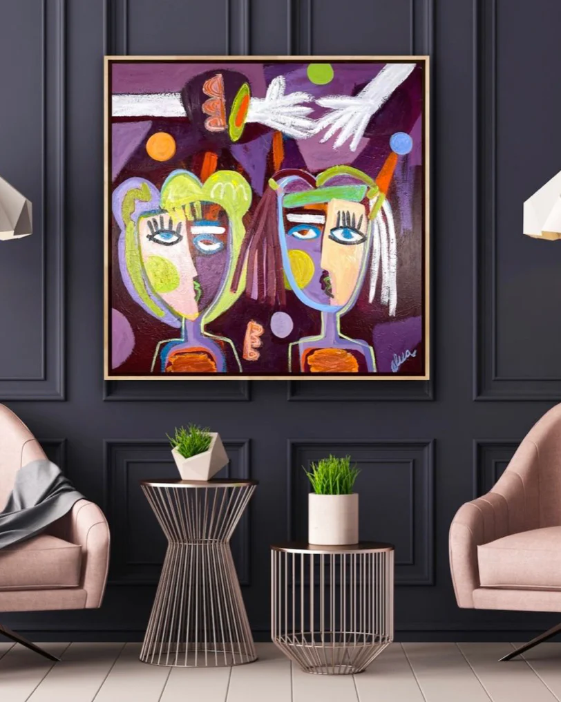 An abstract portrait of two figures painted in rich, deep colors hangs in a contemporary living room.