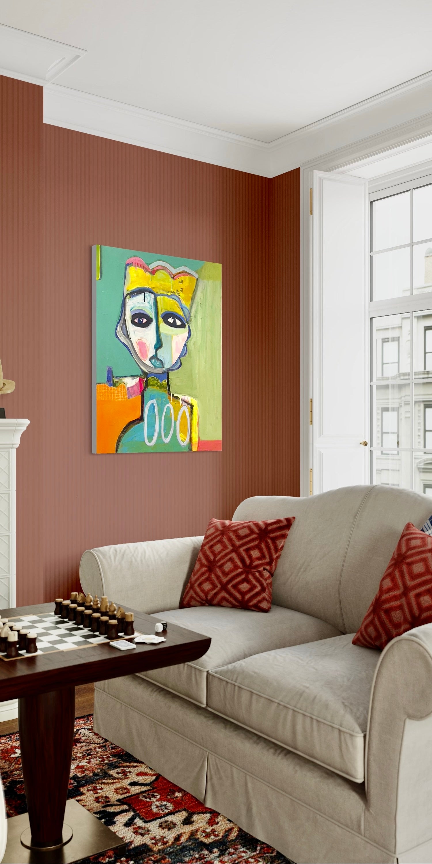 A colorful abstract portrait painting hangs in a cozy living room.